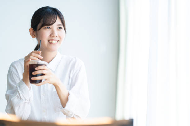 istock Japanese woman drinking coffee in a cafe 1421442074