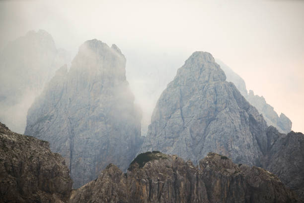 A series of breathtaking views capturing the dramatic rock formations and peaks of the Dolomites in northern Italy. The rugged mountain landscapes, with their distinctive jagged summits, offer a spectacular backdrop under overcast skies. These images were taken along the hiking trails near Tre Cime di Lavaredo, showcasing the unique geology and natural beauty of this UNESCO World Heritage Site.