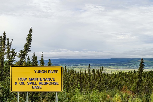 Yukon River and Trans-Alaska Pipeline sign. The Yukon River, longest river in Alaska, USA, and Yukon, Canada, is shown  here north of Fairbanks, Alaska, and about 60 miles south of the arctic. High-up view of the valley.