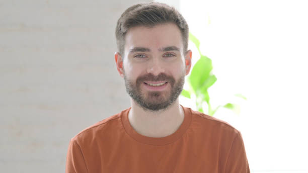 istock Happy Young Man Smiling at Camera 1421447474