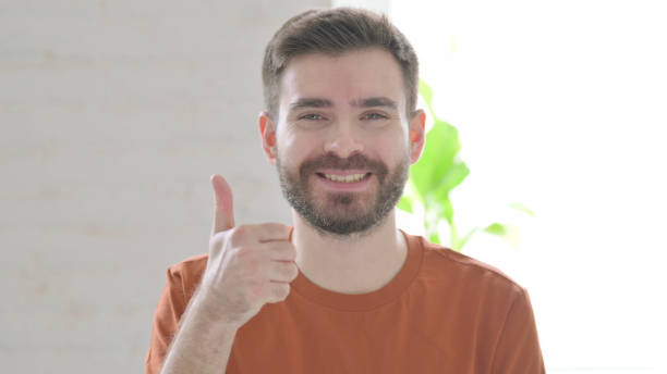istock Young Man showing Thumbs Up Sign 1421447848
