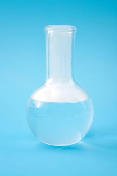 istock Science laboratory, scientific experiment and lab test concept with dry ice in a glass chemistry beaker isolated on blue background 1421452482