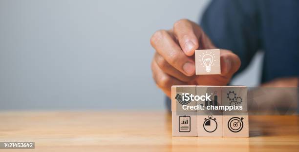 Business Strategy Action Plan Goal And Target Hand Stack Woods Block Step On Table With Icon About Business Strategy And Action Plan Business Development Concept Stock Photo - Download Image Now