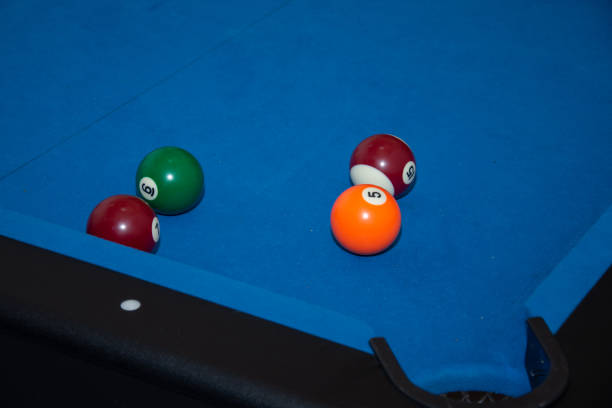 istock Hand with cue aiming on billiard ball at table 1421453862