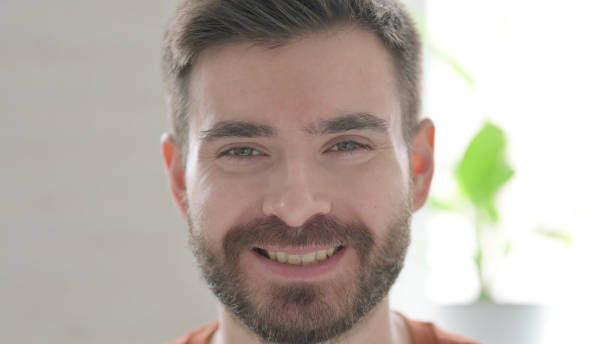 istock Face of Young Man Smiling at the Camera 1421455052