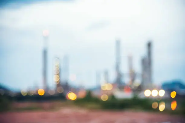 Photo of Blurred background Oil refinery gas petrol plant industry crude tank, chemical factory. Blurry background copy space of petroleum barrel fuel oil refinery abstract defocused for web banner template