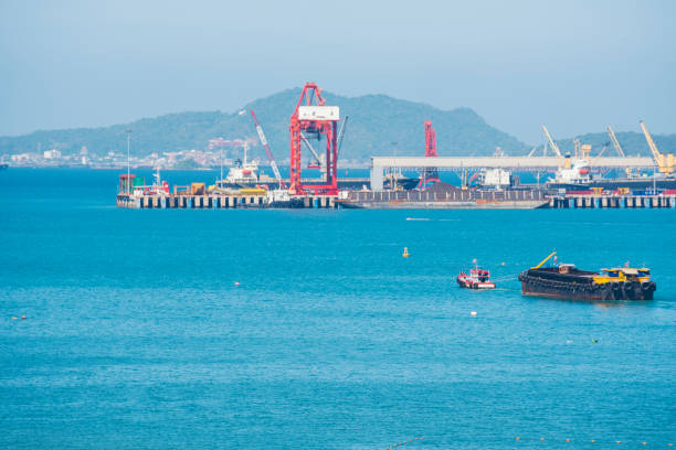 istock Engineering shipping crane depot at logistic export terminal control. Warehouse freight background container yard loading quayside harbor port. Logistics seascape shipping portal concept 1421455496