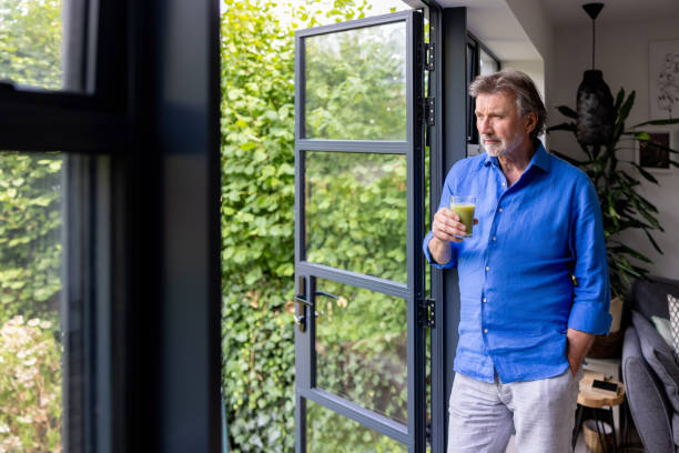 istock Healthy man at home drinking a detox juice for breakfast 1421456319