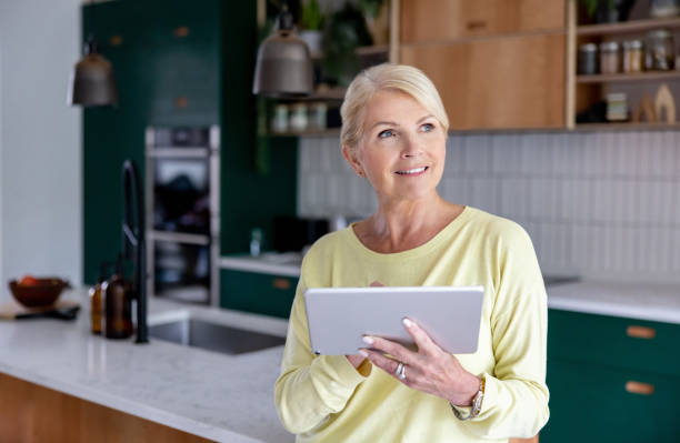 istock Woman using an automated system to control her smart home 1421456340