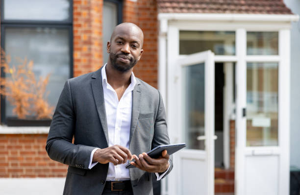 Real estate agent showing a house and using a tablet