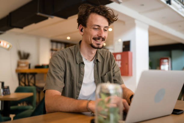 istock One young adult caucasian man work remote from cafe on laptop computer 1421457926
