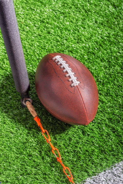 istock Looking down on an American football measured for a first down 1421458287