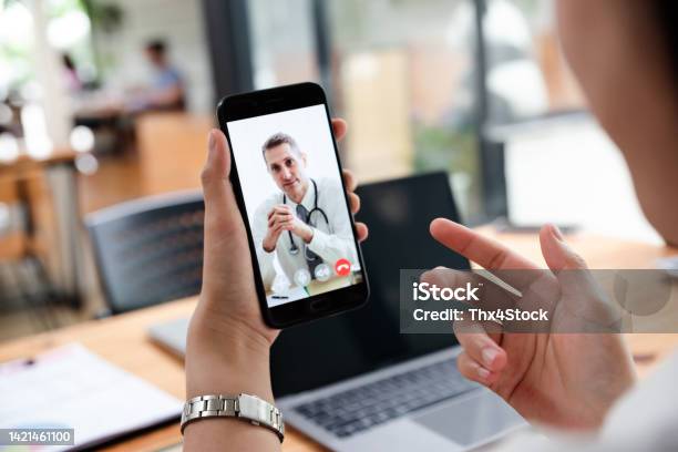 Businesswoman Talking With Doctor Online From Office Stock Photo - Download Image Now