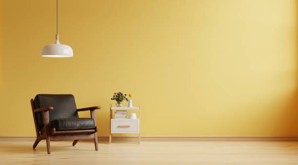 istock Living room has a dark leather armchair on empty yellow wall background. 1421461338