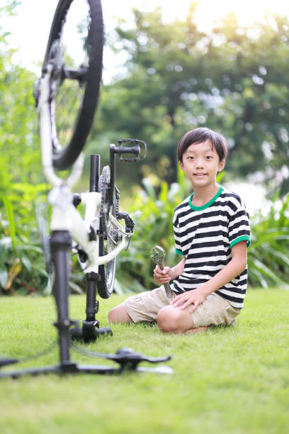 istock Boy repairing the bicycle 1421463198
