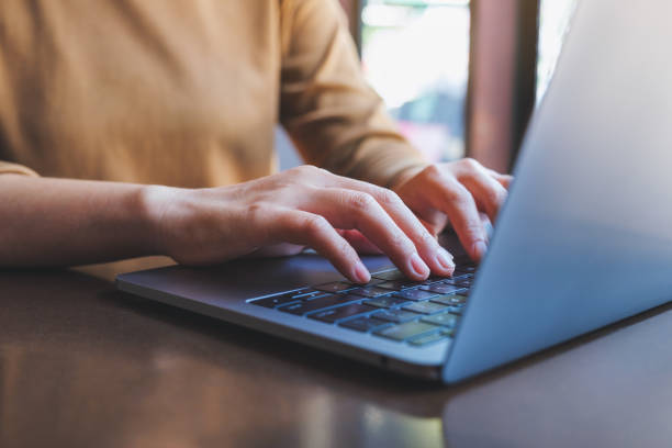 istock Closeup image of hands working and typing on laptop computer keyboard 1421464694