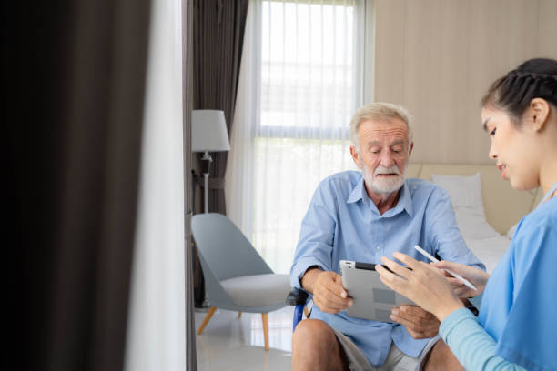 istock Nurse explaining therapy to senior man at home visit. 1421468023