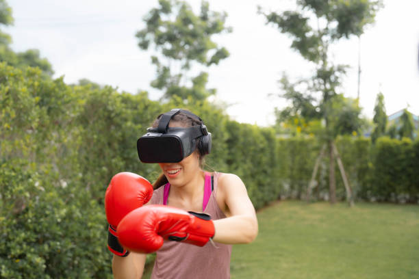 istock Young woman is exercise with virtual reality glasses. 1421471040