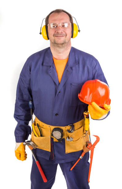 istock Worker in ear muffs holds hard hat. 1421479198