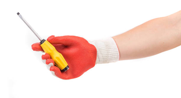 istock Hand in glove with a screwdriver. 1421479329