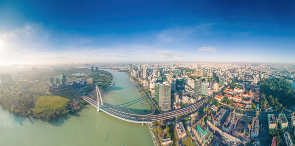 Aerial panorama  view of Ho Chi Minh City skyline and skyscrapers on Saigon river, center of heart business at downtown. Morning view. Far away is Landmark 81 skyscraper. Travel and landscape concept.