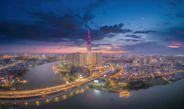 istock Aerial sunset view at Landmark 81 - it is a super tall skyscraper and Saigon bridge with development buildings along Saigon river light smooth down 1421485183
