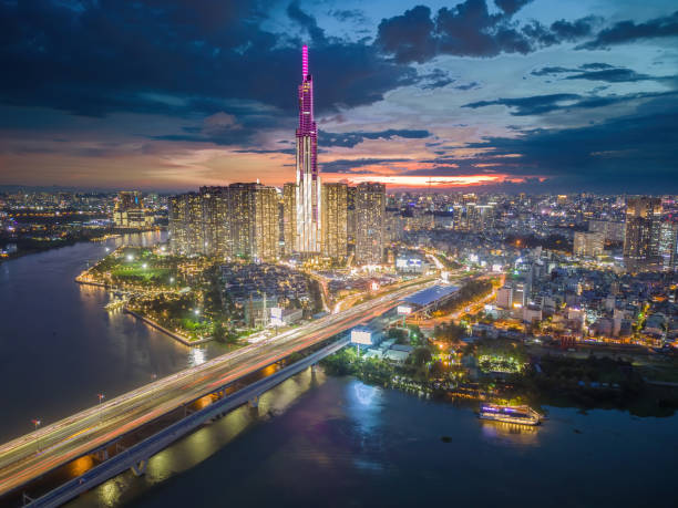 istock Aerial sunset view at Landmark 81 - it is a super tall skyscraper and Saigon bridge with development buildings along Saigon river light smooth down 1421485184