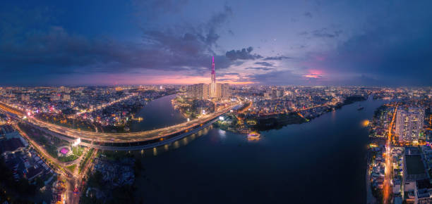 Aerial sunset view at Landmark 81 - it is a super tall skyscraper and Saigon bridge with development buildings along Saigon river, cityscape in the night