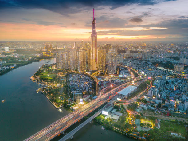 istock Aerial sunset view at Landmark 81 - it is a super tall skyscraper and Saigon bridge with development buildings along Saigon river light smooth down 1421485225