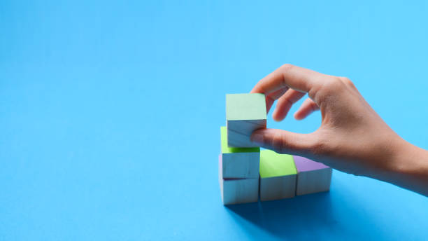 istock Hands choosing colorful wooden blocks 1421488084