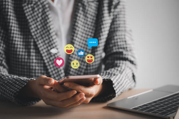 istock woman using smart phone with emotional icons 1421488313