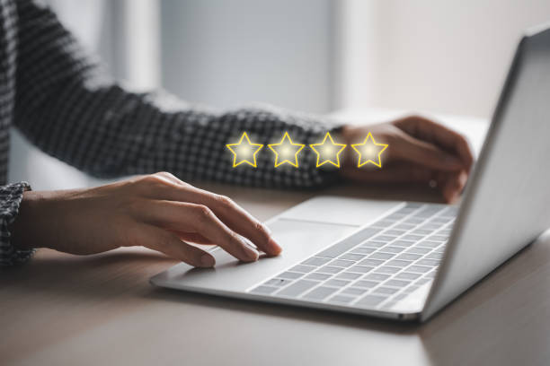 istock closeup woman's hands using laptop with 4 stars above 1421488406