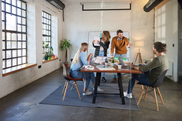 istock Young happy creative team having a meeting at casual office. 1421498971