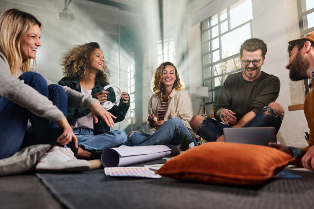 istock Happy creative team having fun on casual meeting in the office. 1421499090