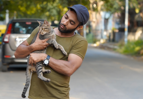 Indian man holding a cat