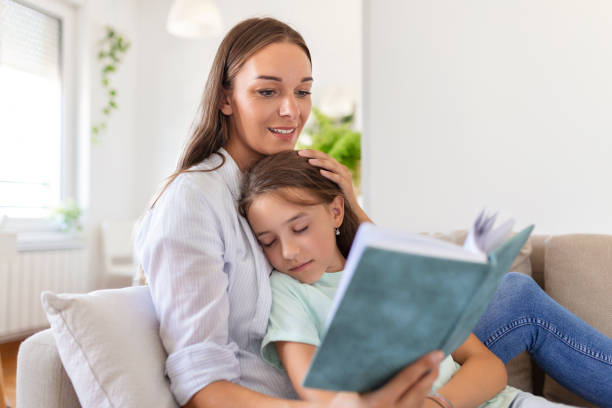 istock daughter feel asleep while her mother is reading a book to her . 1421502337