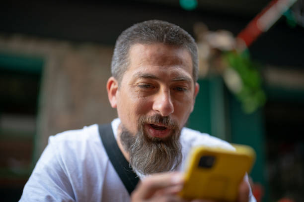 istock Using mobile phone with facial expressions 1421502790