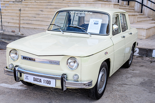 Bucharest, Romania, 2 October 2021: Old dark vivid blue Romanian Dacia 1100 classic car produced in year 1969, parked in a street at an event for vintage cars collections, in a sunny summer day
