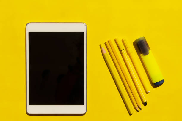 Yellow pencils and pen on yellow background