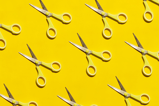Yellow Scissors on Yellow Background