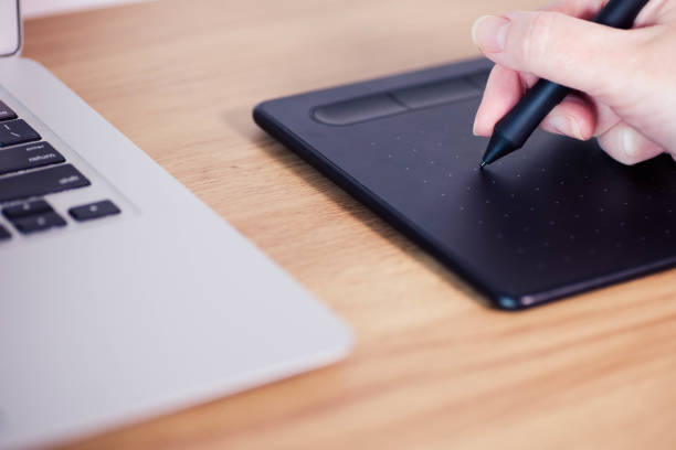 istock Graphic Tablet used for illustration and business on a desk 1421518986