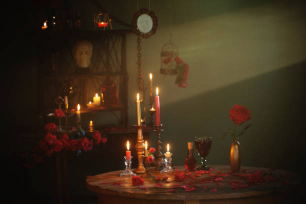 istock magic potion with red roses and burning candles in dark room 1421519772
