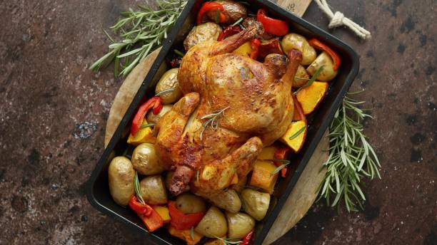 istock Whole roasted turkey or chicken with pepper, pumpkin, potatoes, carrots 1421521692