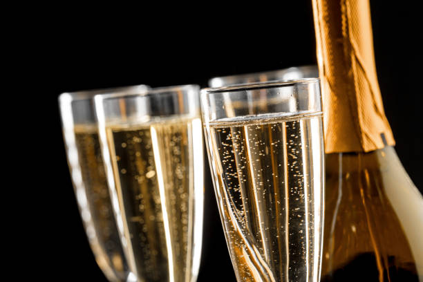 istock glasses of champagne with the bottle 1421521804