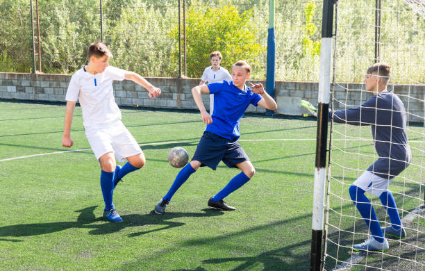 istock Football game - defender knocks ball from attacker 1421522087
