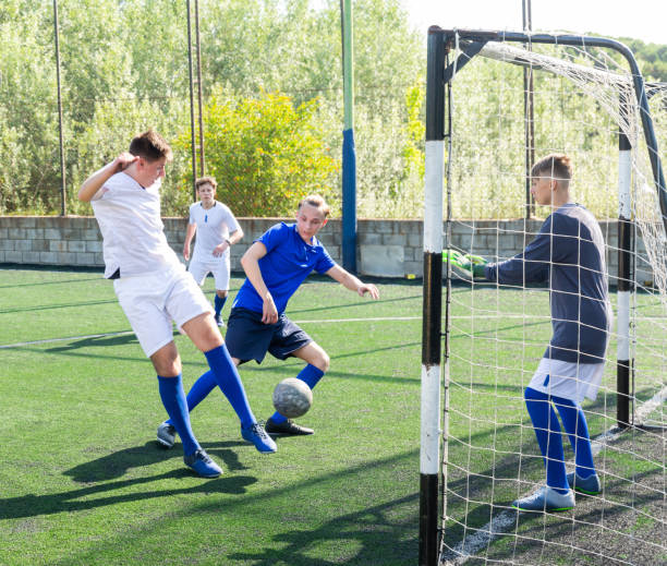 istock Junior football teams having golmouth scramble 1421522098