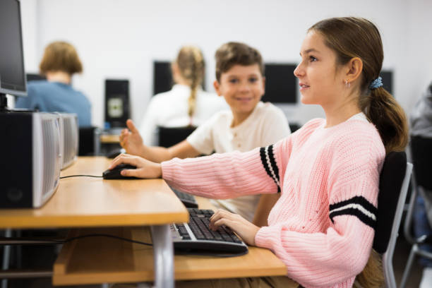 istock Young boy and girl in computer class 1421522939
