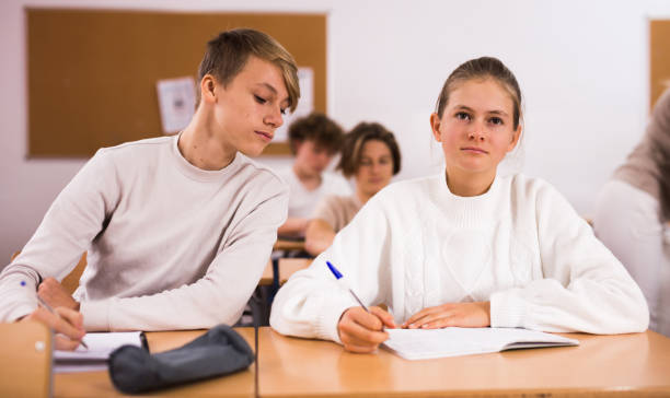 istock Group of school kids and teacher during lesson 1421524344