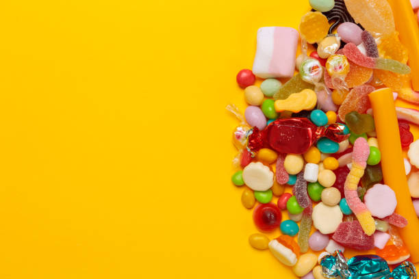 istock colored candies on yellow background 1421524398