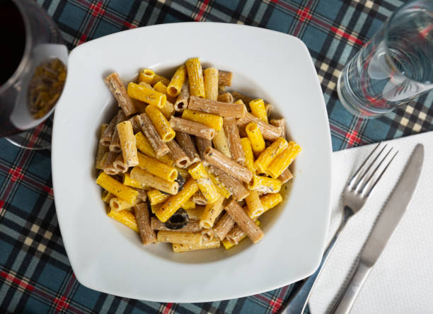 Traditional rigatoni pasta with chopped bacon and cream sauce in plate Traditional rigatoni pasta with chopped bacon and cream sauce in white plate tomato rigatoni stock pictures, royalty-free photos & images